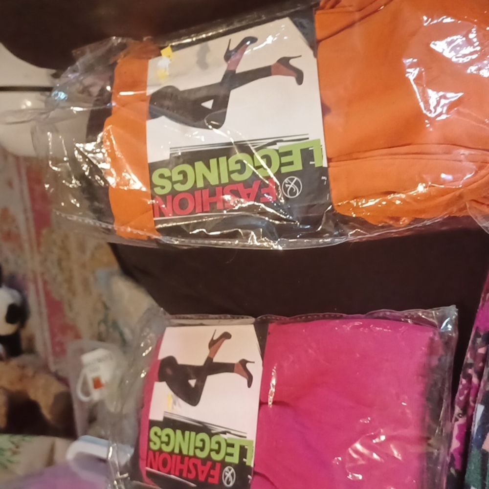 Two pair of Medium fashion leggings..pink and orange.